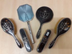 An Edwardian 5 piece silver and tortoiseshell brush set with inlaid silver design, makers initials