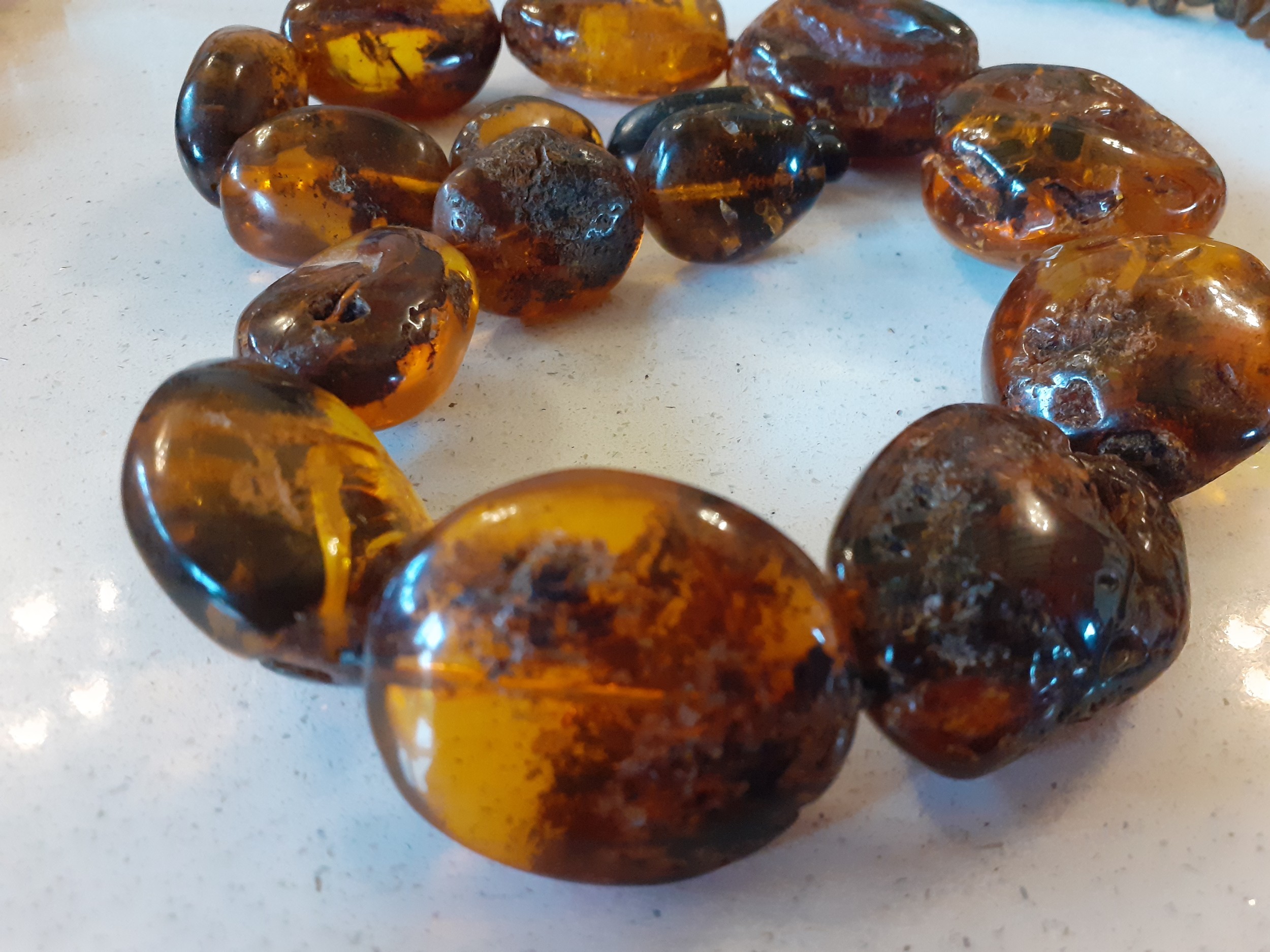 A vintage amber necklace having 15 beads of various sizes and shapes together with 2 vintage rough- - Image 6 of 9