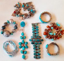 A quantity of turquoise stone and turquoise coloured bead costume bracelets on white metal and
