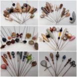 A collection of Victorian, Edwardian and later vintage hat pins mounted on later decorative doll