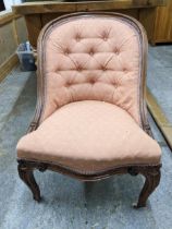 A Victorian mahogany framed button back upholstered nursing chair, carved French carbide legs on