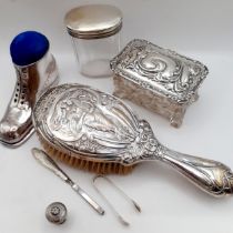 A decorative lot of silver plated and silver tone dressing table items to include a pin cushion in