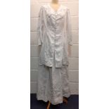 A late 19th/ early 20th Century white cotton and embroidered driving outfit comprising a longline