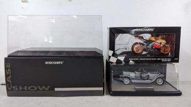 A boxed Minichamp Honda RC211V Valentino Rossi model together with two display cases and a