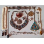 Vintage costume jewellery to include an Indian gold tone and red coral brooch of a seated