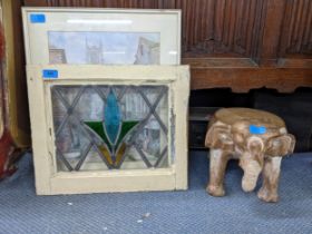 Three items to include an elephant stool, a 1930's stained glass panel and a print (originally by