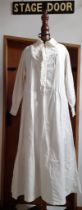 A late Victorian white cotton nightgown having crotchet trim to the collar, front closure and