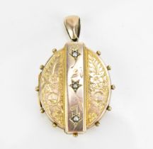 A Victorian yellow metal and pearl inset locket, of oval form with central band set with pearls in
