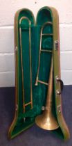 A Skylark gold tone trombone in a hard case, made in China. Location:RWF Condition: Some