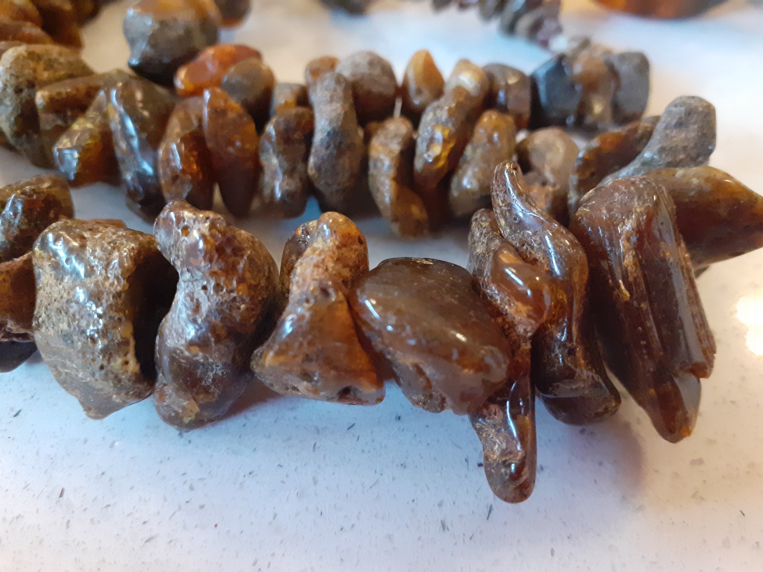 A vintage amber necklace having 15 beads of various sizes and shapes together with 2 vintage rough- - Image 8 of 9