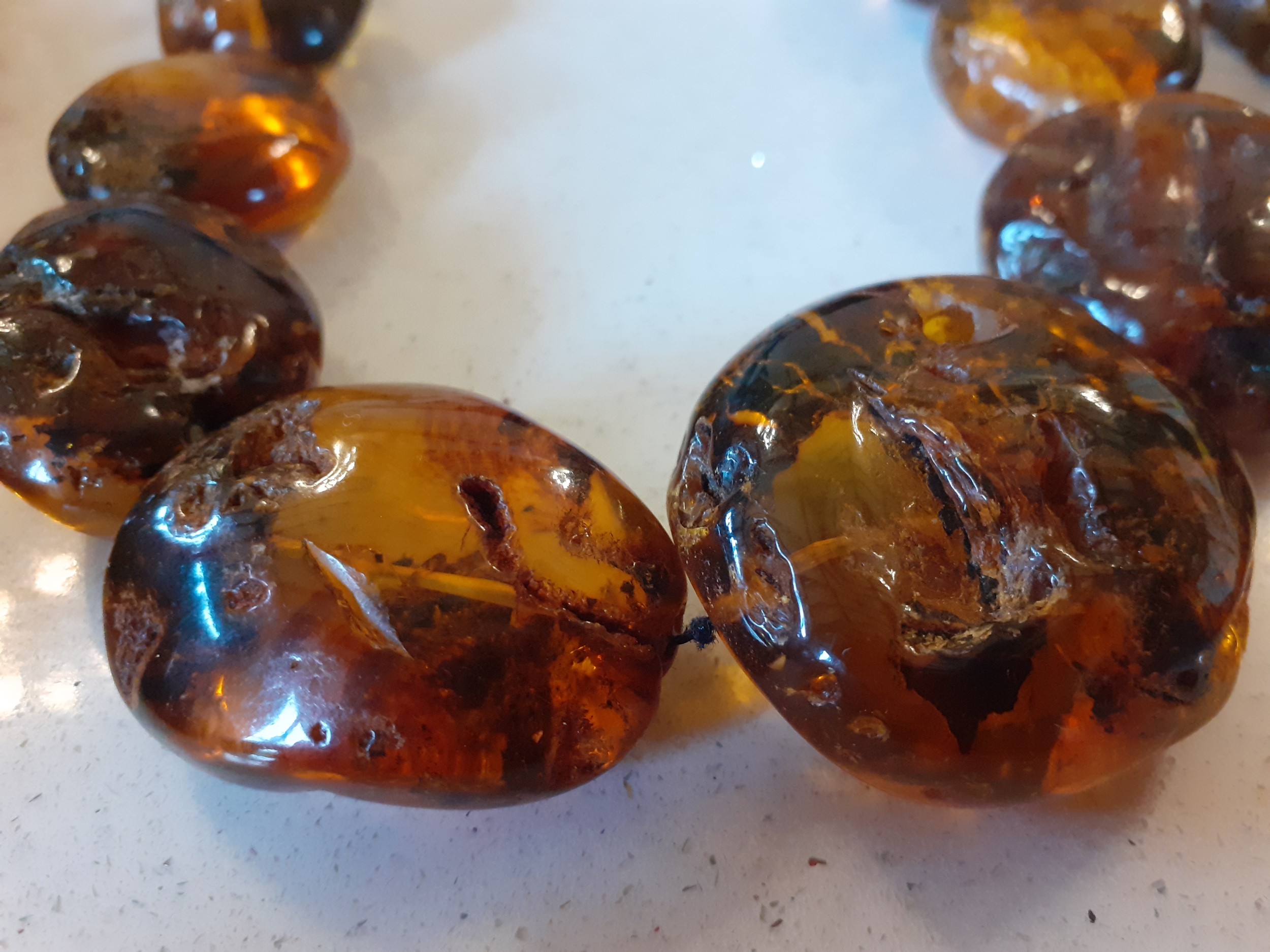 A vintage amber necklace having 15 beads of various sizes and shapes together with 2 vintage rough- - Image 2 of 9