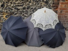 Four vintage umbrellas and parasols to include a Parisian black umbrella with cream lace under layer