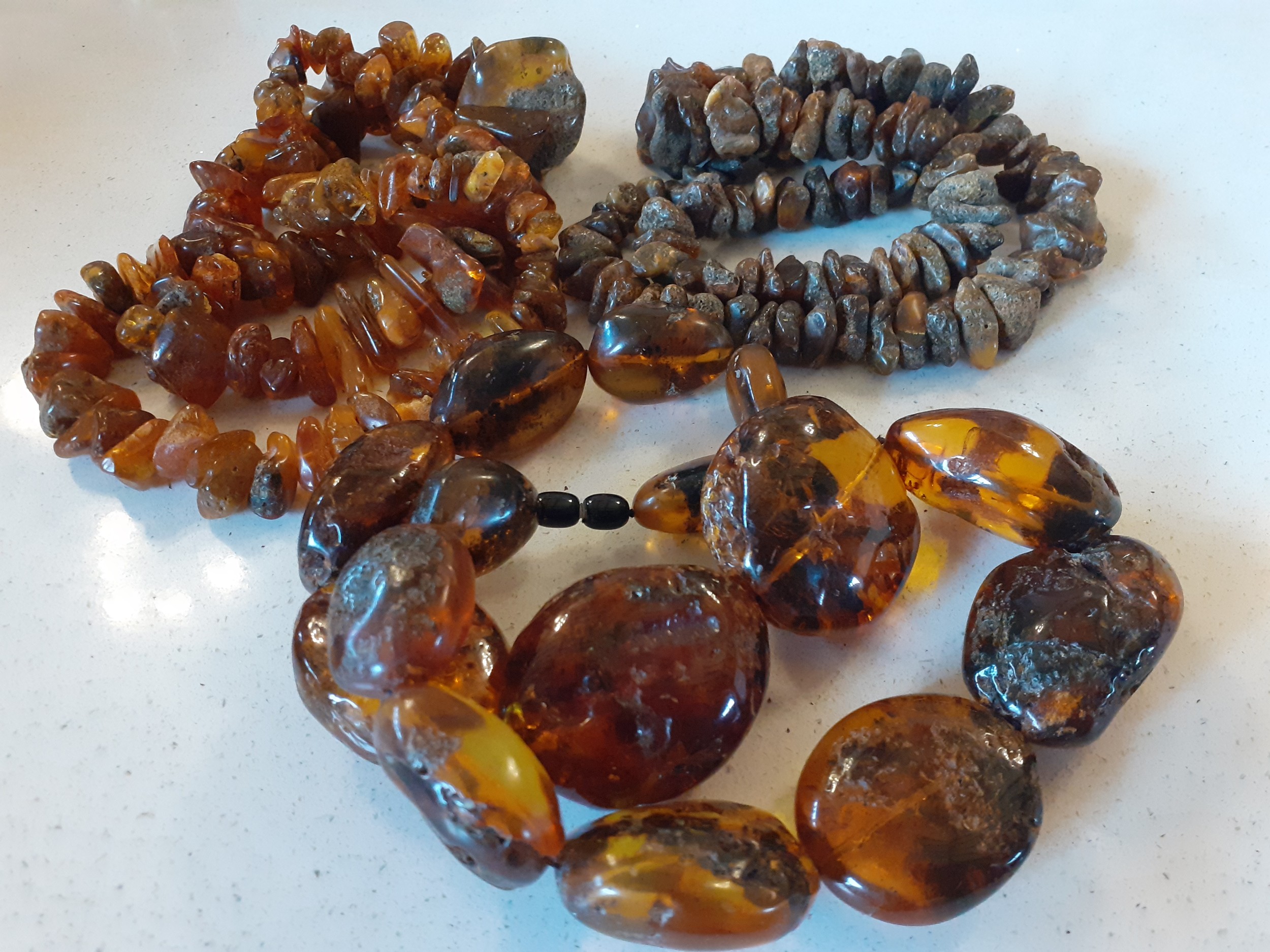A vintage amber necklace having 15 beads of various sizes and shapes together with 2 vintage rough- - Image 9 of 9