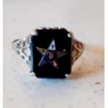 An Art Deco 14 carat white gold and black onyx ring engraved with an Eastern Star pentagram