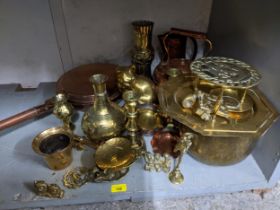 Brass and copper to include a kettle on Indian planter, jugs, vases, model cat, a bedwarmer and