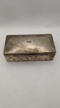 A London 1934 silver cigarette box having machine turned design lid Location: