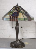 An Art Nouveau style table lamp with a Tiffany style shade Location: