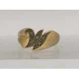 An 18ct gold ring in the form of the letter M set with diamonds, total weight 4.6g Location: