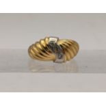 An 18ct gold and platinum croissant style ring set with diamonds, total weight 4.4g Location: