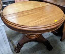 A 19th century mahogany extending dining table, with a turned tapered column of carved paw feet 73cm