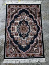 A contemporary Persian machine woven rug, floral designs on a block ground, tasselled ends. 168