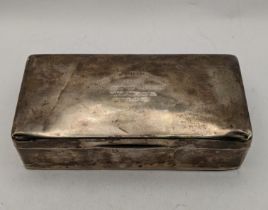 A silver cigarette box having engraved writing to the lid Location: