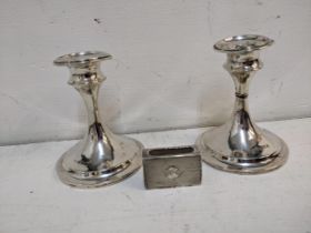 A pair of 20th century silver candlesticks A/F and a small matchbox holder Location: