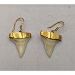 A pair of 18ct gold earrings stamped 750 set with fish teeth Location: