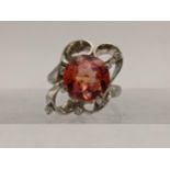 A 800 stamped Platinum ring set with an orange tourmaline and diamonds, total weight 11.2g Location:
