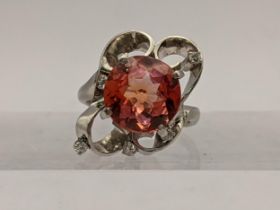 A 800 stamped Platinum ring set with an orange tourmaline and diamonds, total weight 11.2g Location: