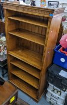 A modern solid oak open bookcase having six tiers and on bracket shaped feet, 185.5cm h x 91.5cm w