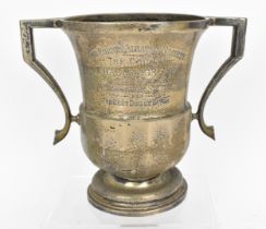 A George V silver trophy cup by T.H.E Birmingham 1927 of raised form with twin handles on a short