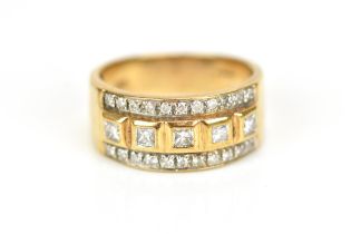 A 9ct gold and diamond dress ring, set with a central row of five bezel set princess cut diamonds,
