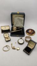 A silver pusher and spoon and napkin ring, a compact, a gold plated watch, a stopwatch, tiger eye