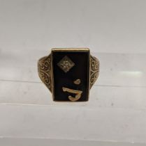 A 9ct gold and black onyx ring inset with a pace stone, total weight 5.4g, Location