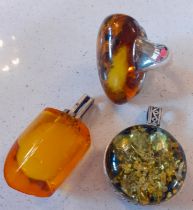 A contemporary oversized amber ring on silver mount, stamped 925 together with a Baltic green