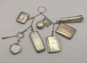 A silver and white metal Chatelaine to include a Birmingham 1912 Sovereign case having an engraved