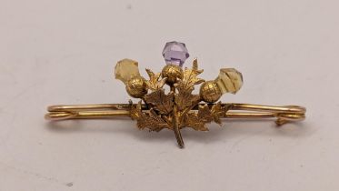 A 9ct gold Scottish thistle brooch inset with an amethyst and two citrines, 2.1g Location: