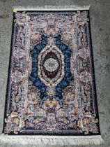 A contemporary small Persian style, machine woven rug, floral design with boarders around a