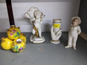 A group of two Victorian Royal Worcester porcelain vases, and a figurines of a young boy to
