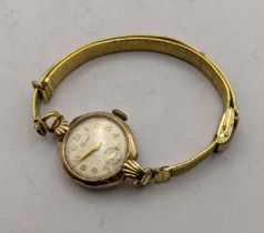 A 20th century ladies 9ct gold wrist watch on a gold plated bracelet Location:
