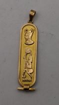 A yellow metal Egyptian hieroglyphics pendant 5.9g Location: