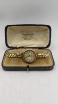 An early 20th century 9ct gold ladies wristwatch on a gold pated expanding bracelet, Location: