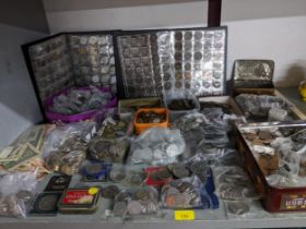 A large collection of UK and world coinage, commemorative coins, and various banknotes to include