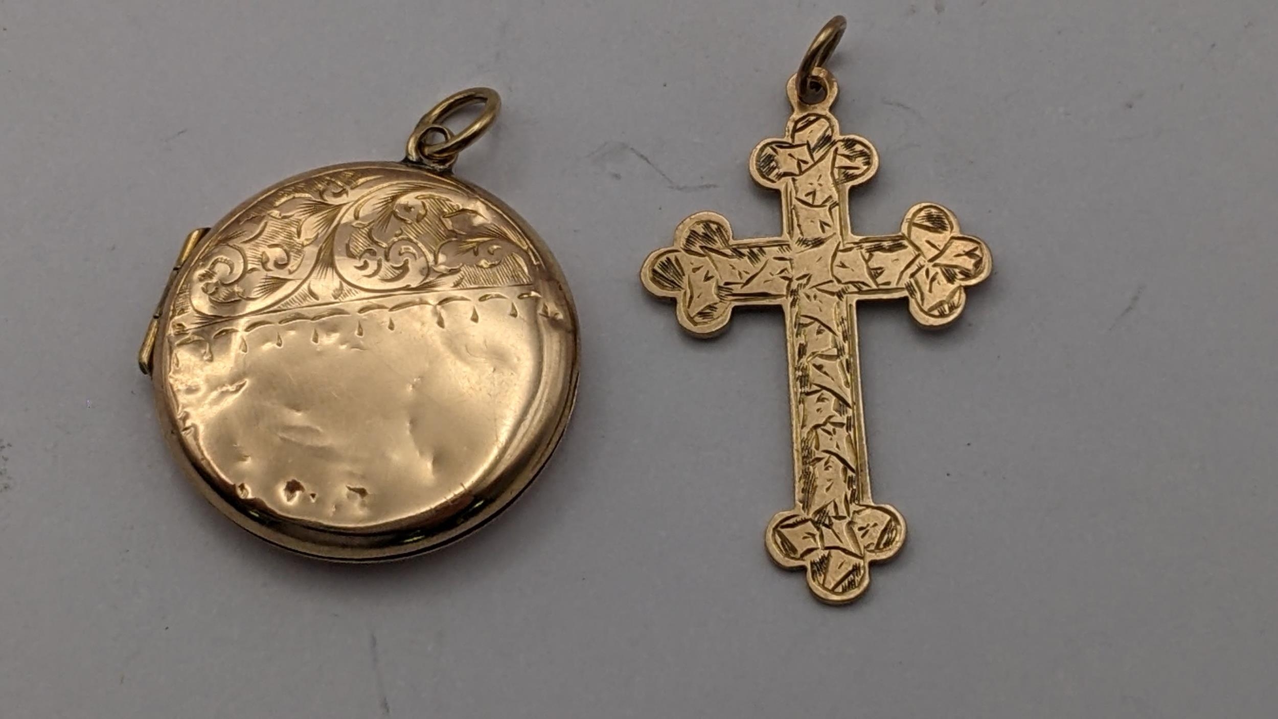 A 9ct gold cross pendant, 2.2g, together with a 9ct front and back pendant Location: