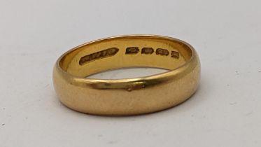 A 22ct gold wedding band, 5.4g Location: