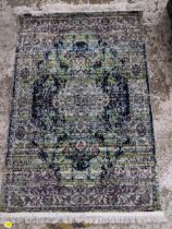 A contemporary machine woven polyester filament rug, floral pattern on a multicoloured lined ground,