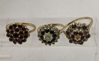 Three 9ct gold cluster rings one set with red garnets, one set with diamonds and rubies and one