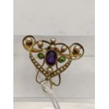 A late 19th/early 20th century yellow metal brooch, stamped 15, set with seed pearls and an amethyst