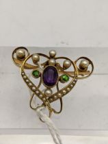 A late 19th/early 20th century yellow metal brooch, stamped 15, set with seed pearls and an amethyst